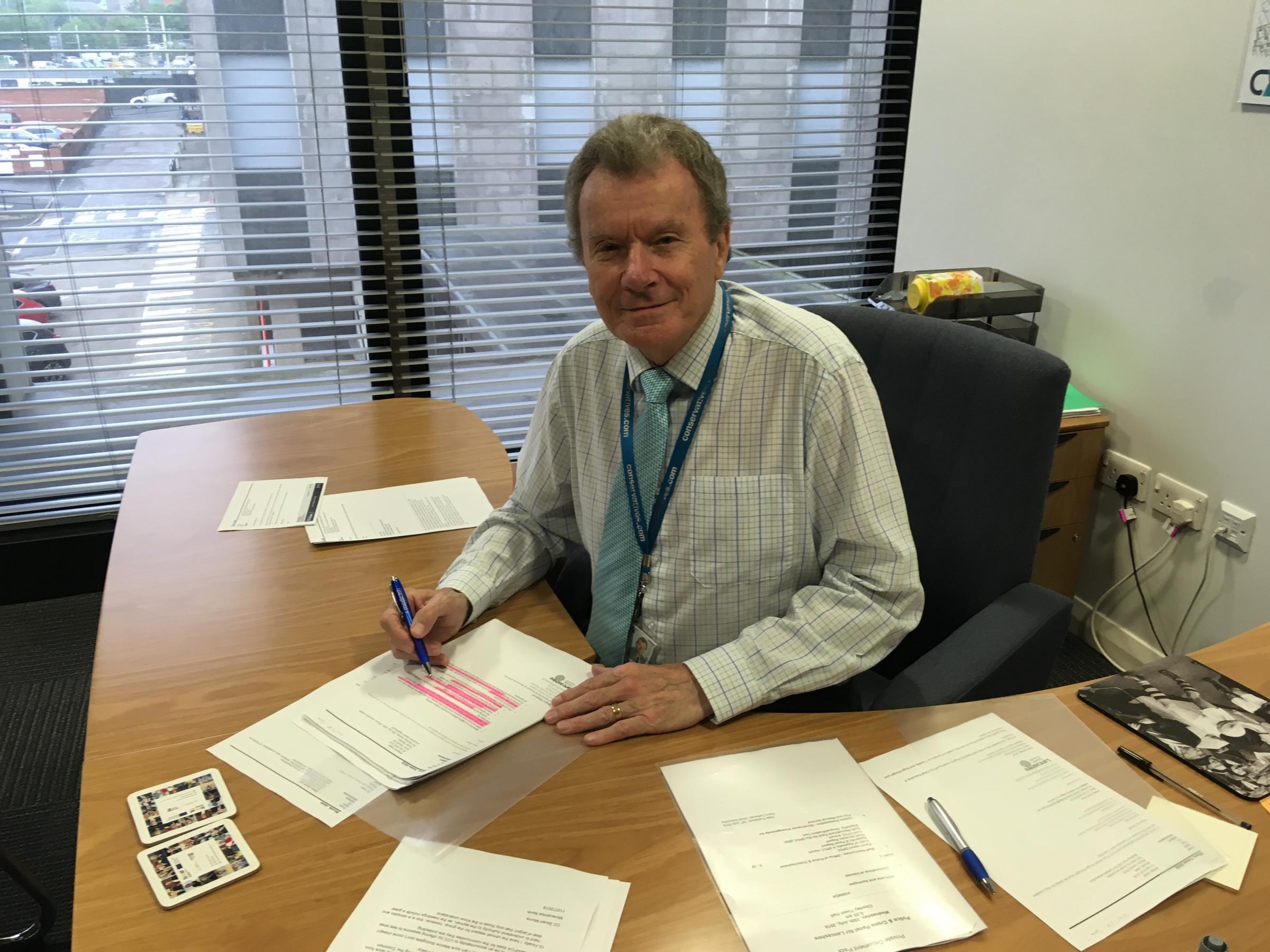 Geoff Driver at his desk with his Clarets mug and mousemat.