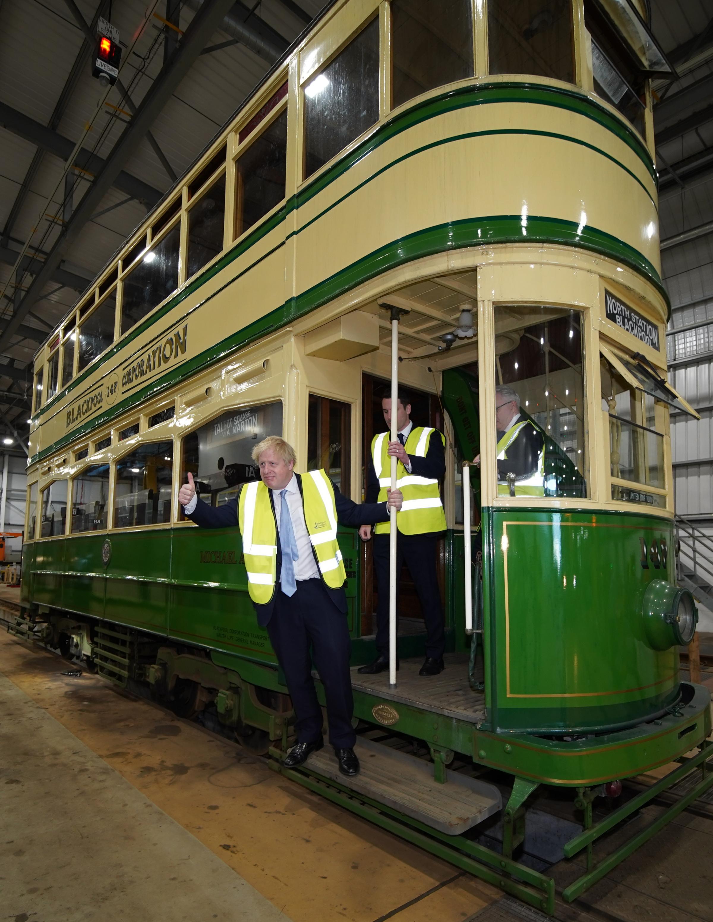 Prime Minister Boris Johnson (right) viewing a vintage tram during a visit to Blackpool Transport Depot