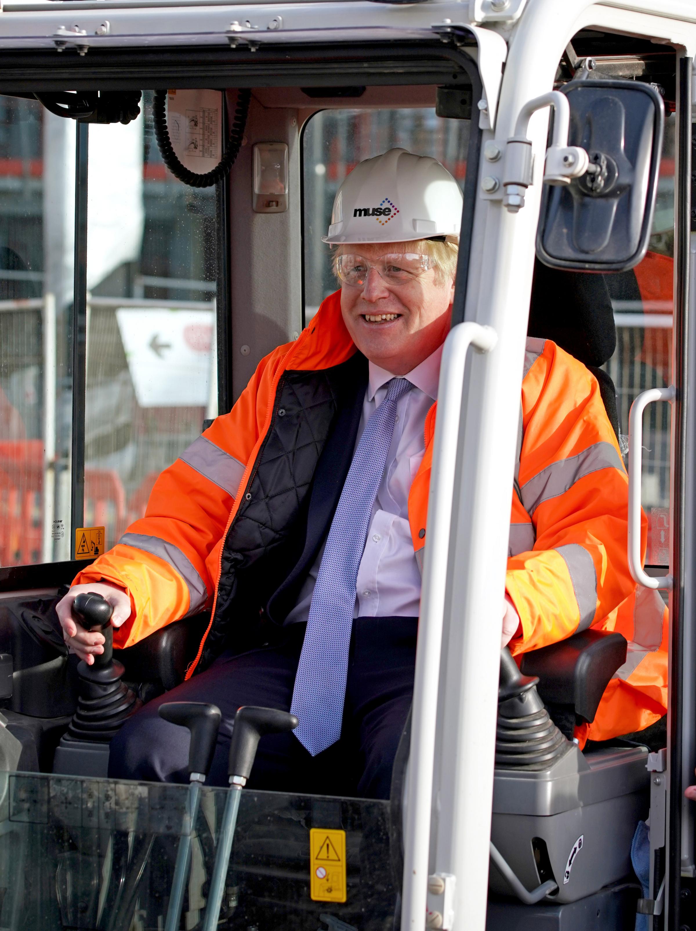 Prime Minister Boris Johnson in the cab of a construction digger during a visit to Talbot Gateway in Blackpool