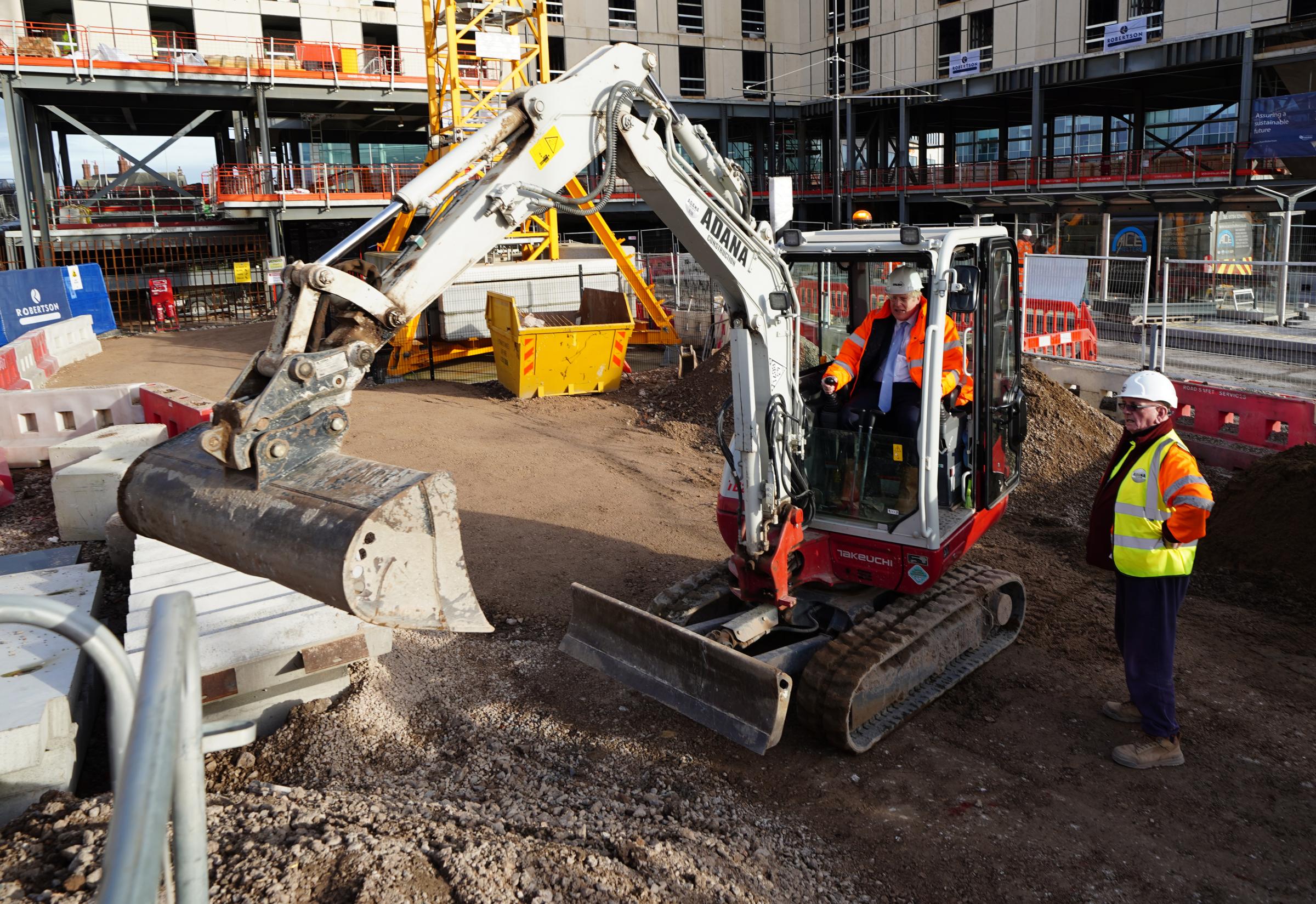 Prime Minister Boris Johnson in the cab of a construction digger during a visit to Talbot Gateway in Blackpool. Picture date: Thursday February 3, 2022.